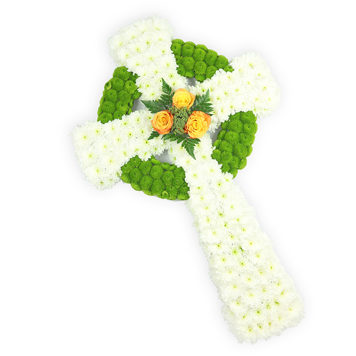 A striking, sculptural Celtic cross made entirely from fresh flowers, presented on a luminous white background and photographed from above so the circular centre and interlaced arms are clearly visible. The main body is composed of dense clusters of small white spray chrysanthemums; each tiny bloom contributes to a velvety, matte surface that communicates quiet dignity and purity. Sections of bright, almost lime apple-green button chrysanthemums are precisely placed to outline the central ring and to alternate within the horizontal arms, creating a plush, patterned contrast that reads like a living Celtic knot. Anchoring the design, a compact cluster of three radiant orange-yellow roses sits exactly at the cross's heart-warm, sunlit petals that stand out against the cool whites and greens-surrounded by a few dark green fern sprigs that add depth, shadow, and the scent of fresh foliage. The lighting is soft and even, revealing petal texture and the three-dimensional contours of the piece, while the overall mood is one of respectful remembrance and gentle hope. This arrangement would be fitting for commemorations of Irish heritage or a funeral service in Yiewsley, Sipson, or near Heathrow; it reads as both reverent and comforting, a handcrafted floral tribute that speaks of enduring memory, community, and careful florist craftsmanship delivered with sensitivity to local customs and places.
