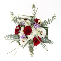 From a Yiewsley florist's perspective, this opulent bouquet is a study in balanced contrasts and calming textures. At its center, richly colored red roses stand as emblems of enduring love, their velvety petals carefully arranged for maximum impact and depth. Flanking them, white gerbera daisies with their bold chocolate centers radiate brightness and optimism, evoking memories of open markets and busy mornings along Yiewsley High Street. Dancing above the main display, branches of eucalyptus with their silvery undertones introduce a fresh, invigorating scent-instantly transporting one to riverside walks in nearby Little Britain Lake. Scattered throughout, soft purple lisianthus adds a contemporary lift, their subtle tones reminiscent of twilight skies over West Drayton Road. Amplifying the tactile palette, clusters of fluff-like white filler flowers create visual softness and a light, airy structure, while the base is elegantly finished with broad, dark green leaves that wrap like a cherished memory. The entire arrangement presents a seamless fusion of color, scent, and emotion-perfect for anniversaries, sympathy, or just-because moments, promising reliable delivery throughout Yiewsley by the experienced team at Flowers Yiewsley.
